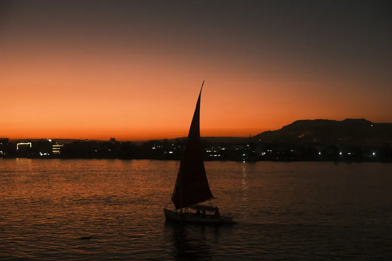 A felucca sailing on the Nile at Luxor after sunset